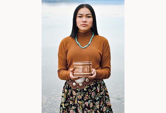 Person holding container of water