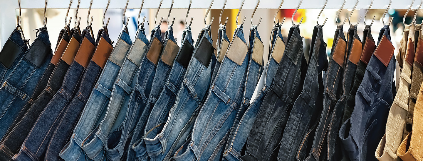 Photo showing a rack of different color jeans