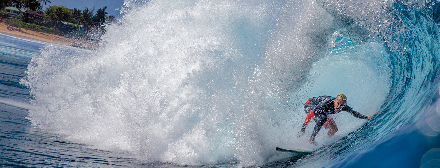 Image of a surfer catching a wave in the ocean